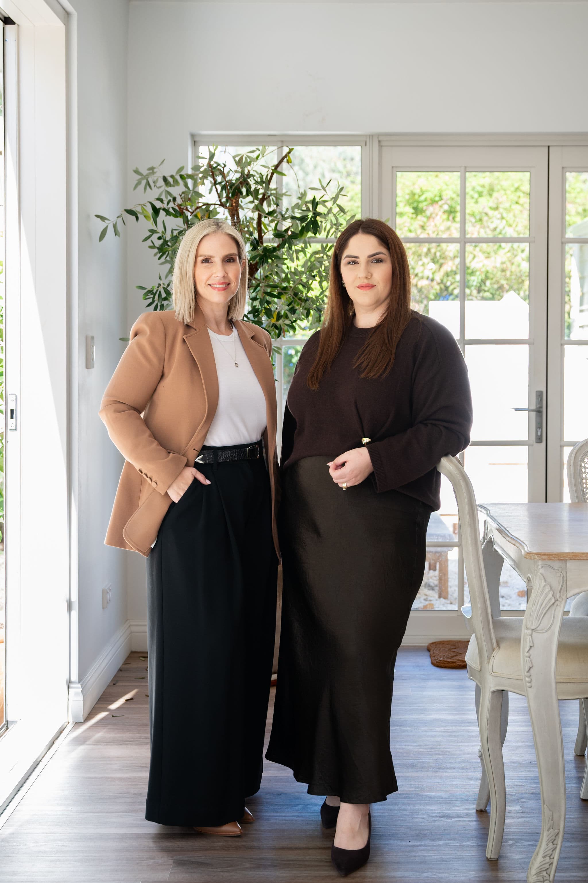 Alana and Simone standing together in the West End Settlements office.